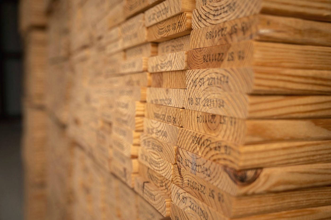 Grade-stamped treated lumber stacked on edge.